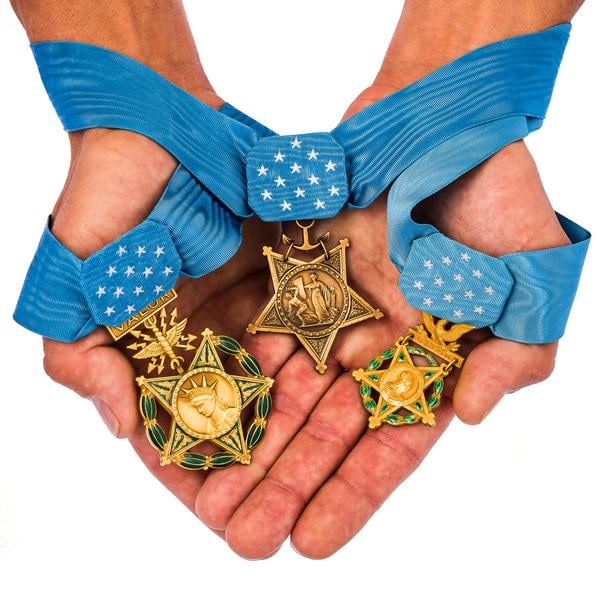 Hands holding medals